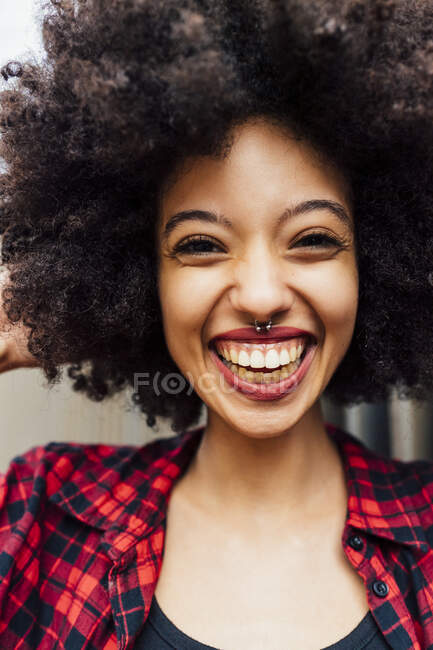 Cheerful young woman with Afro hairstyle and nose ring — Stock Photo