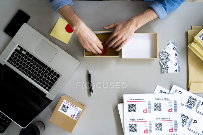 Businessman packing box at desk — Stock Photo