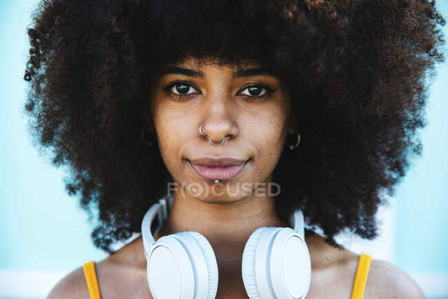 Afro mujer con anillo en la nariz y auriculares - foto de stock