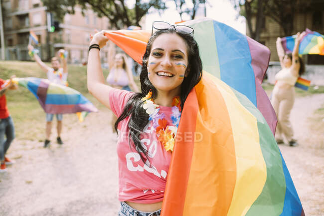 Happy woman with rainbow flag in pride event to protest for equal rights — Stock Photo