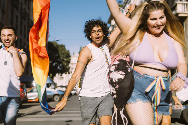 Happy male and female activists walking on street — Stock Photo