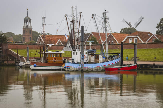 Germany, Lower Saxony, Ditzum, Fishing boats moored in town harbor — Stock Photo