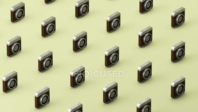 Padrão tridimensional de câmera antiquada em fileiras contra fundo verde — Fotografia de Stock