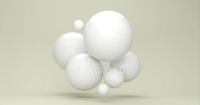 Three dimensional render of white bubbles floating against green background — Stock Photo