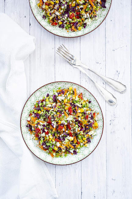 Rainbow salad made out of broccoli, carrot, corn, cauliflower, red ...