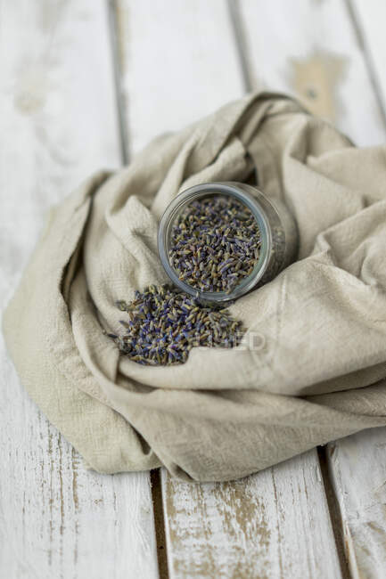 Lavender seeds falling from jar — Stock Photo
