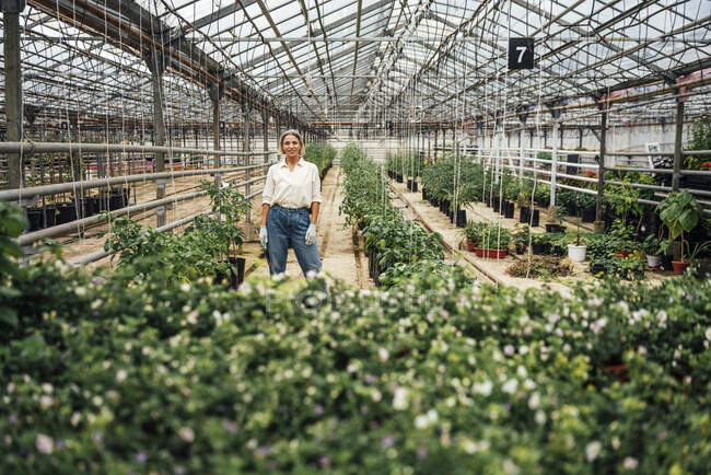 Esperta di agricoltura femminile in piedi presso vivaio — Foto stock