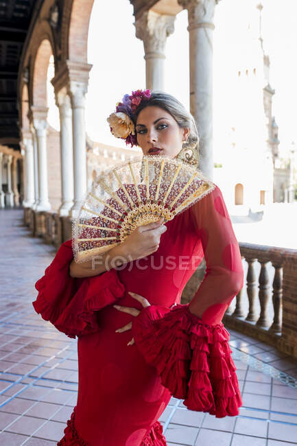 Female flamenco artist holding hand fan while standing at Plaza De Espana, Seville, Spain — Stock Photo