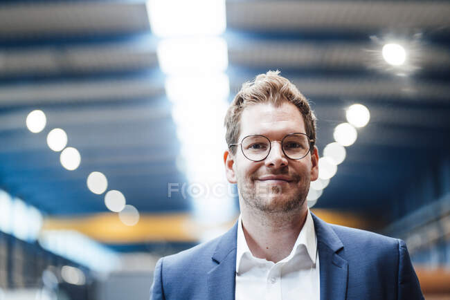 Smiling businessman at metal industry — Stock Photo