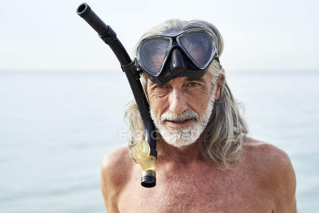 Hombre sin camisa con gafas de natación en la playa - foto de stock
