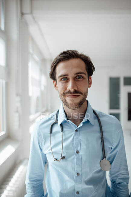 Посмішка лікаря чоловічої статі з стетоскопом в офісі — стокове фото