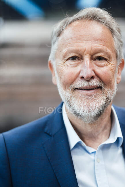 Smiling male business professional in industry — Stock Photo