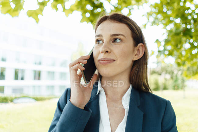 Female freelancer talking on mobile phone — Stock Photo