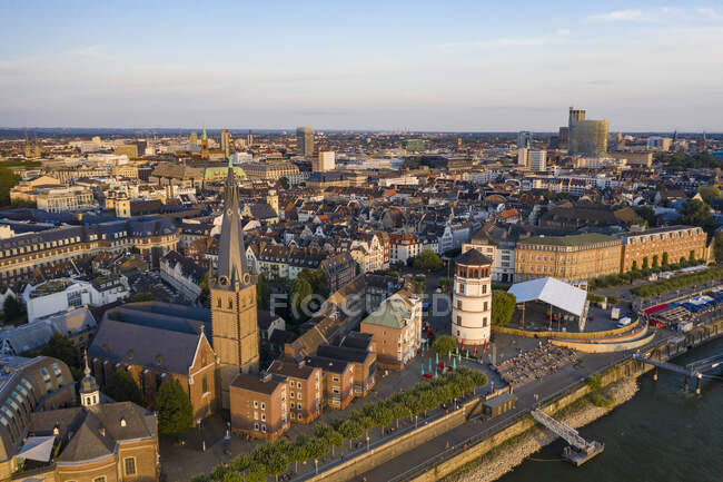 Germany, North Rhine-Westphalia, Dusseldorf, Aerial view of Burgplatz, Schlossturm and Saint Lamberts Church at dusk — Stock Photo