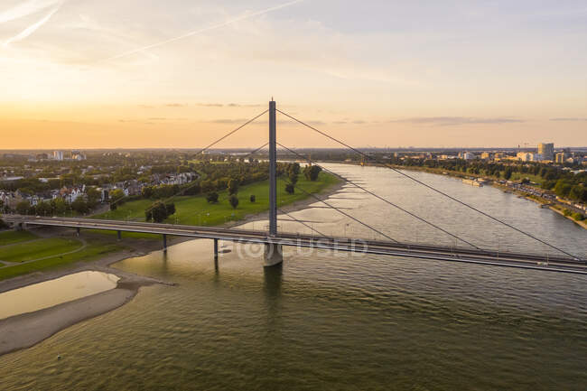 Germany, North Rhine-Westphalia, Dusseldorf, Aerial view of Oberkasseler Bridge at sunset — стокове фото