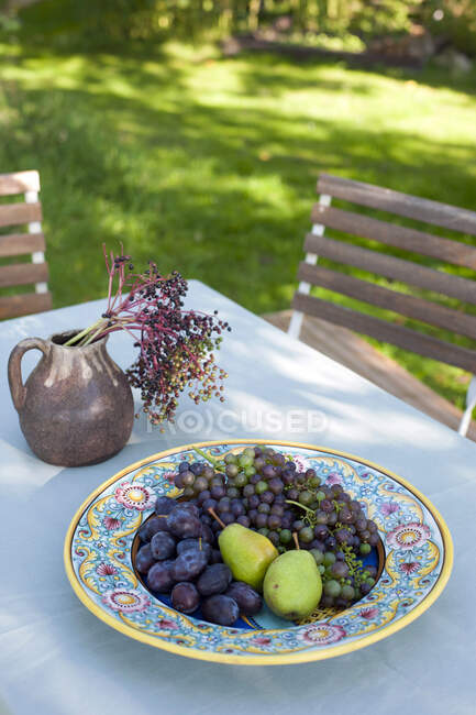 Fresh fruits on outdoor table — Stock Photo