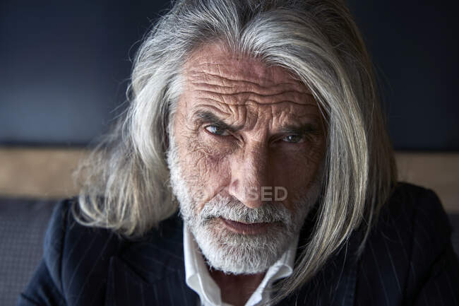 Serious male professional with gray hair at hotel — Stock Photo