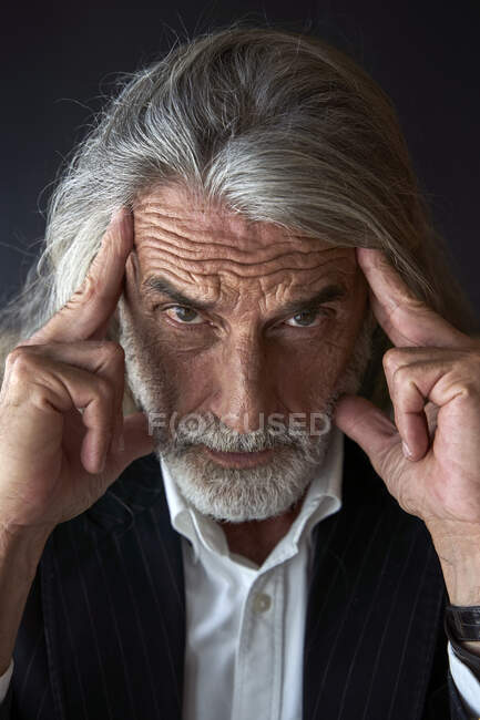 Mature male professional with head in hand at hotel — Stock Photo