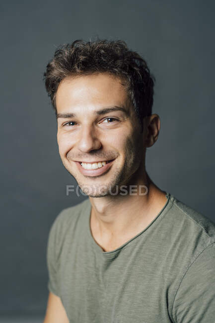 Smiling young man in studio — Stock Photo