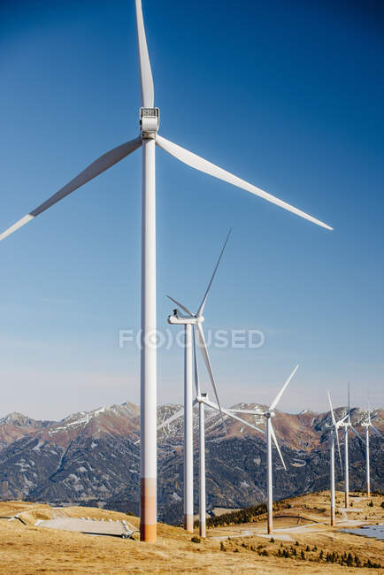 Wind farm turbines standing against clear blue sky in Lachtal — Stock Photo