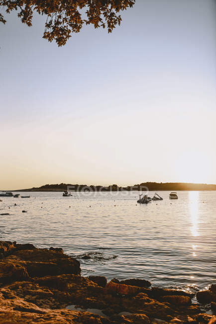 Pôr do sol sobre as águas costeiras — Fotografia de Stock