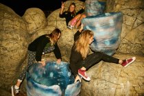 Women having fun on blue stones — Stock Photo