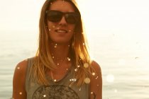 Femme dans la lumière douce du soleil sur la plage — Photo de stock