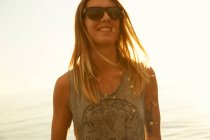 Mulher de óculos de sol na praia — Fotografia de Stock