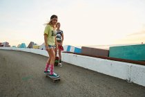 Women with skateboards on parking lot — Stock Photo