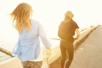 Friends walking at seafront — Stock Photo