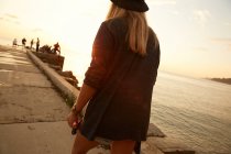 Girl walking at seafront — Stock Photo
