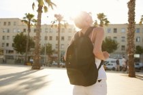 Back view of tourist with black bag standing on street in barcelona — Stock Photo