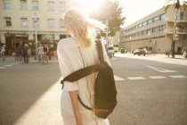 Back view of woman walking with bag on street in barcelona — Stock Photo