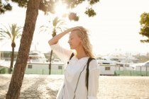 Side view of attractive woman standing on quay in barcelona — Stock Photo