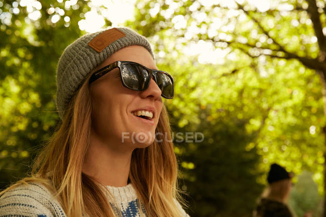 Woman in hat and sweater in forest — Stock Photo