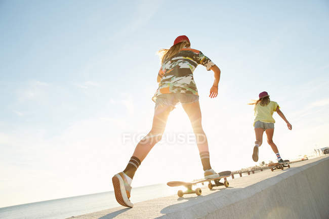 Women riding on skateboards — Stock Photo