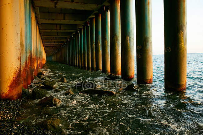 Columnas a orillas del mar al atardecer - foto de stock