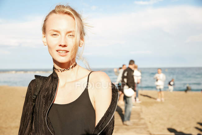 Portrait of attractive woman standing on beach in barcelona — Stock Photo
