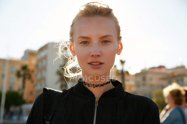 Portrait of young woman looking at camera on street in barcelona — Stock Photo