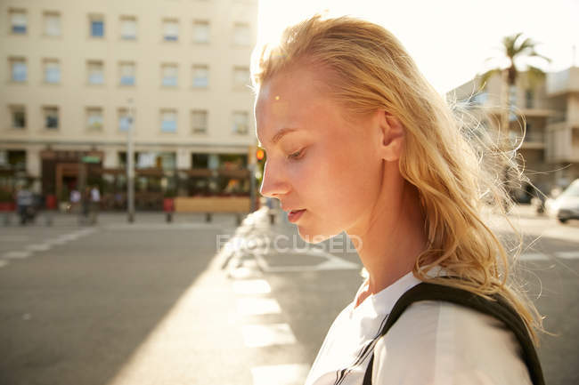 Side view of woman walking with bag on street in barcelona — Stock Photo