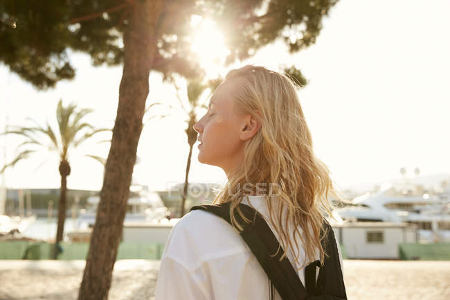 Side view of attractive woman standing on quay in barcelona — Stock Photo