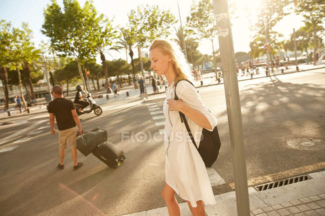 Side view of woman standing with bag on street in barcelona — Stock Photo