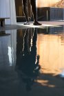 Man's reflection on pool — Stock Photo