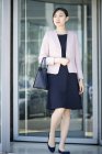Asiatique Businesswoman sortie immeuble de bureaux — Photo de stock