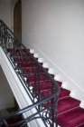 Escalera con alfombra roja - foto de stock