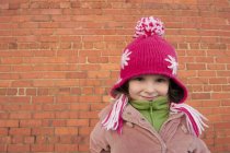 Little girl wearing knit hat outdoors, portrait — Stock Photo