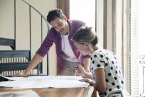 Wife and husband reviewing blueprints for home renovation — Stock Photo