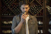 Sommelier smelling wine cork in wine shop — Stock Photo