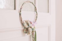 Wreath hanging on door — Stock Photo