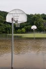 Flooded outdoor basketball court — Stock Photo